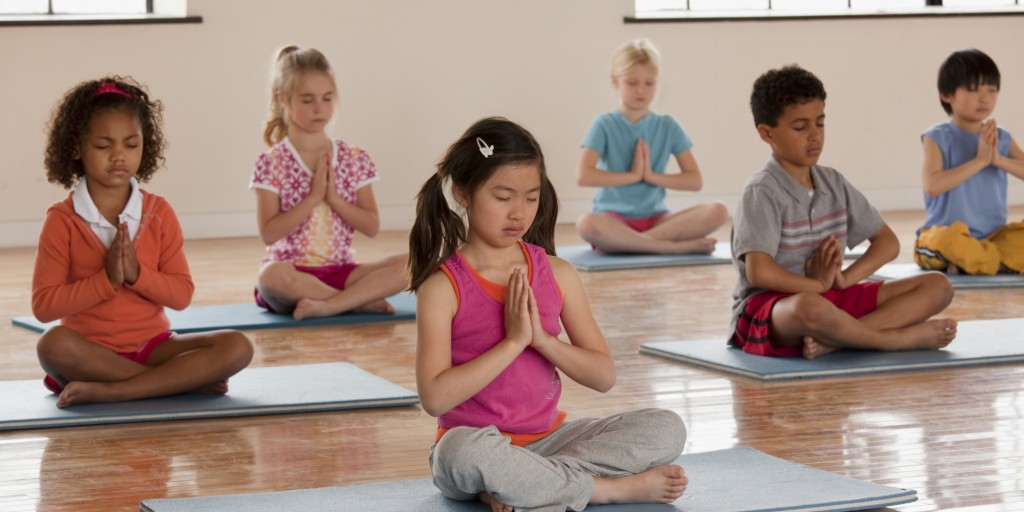 Children exercising in yoga class